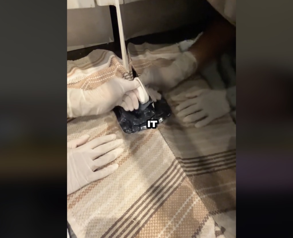 water gushing out out of secret washing machine compartment in a TikTok video